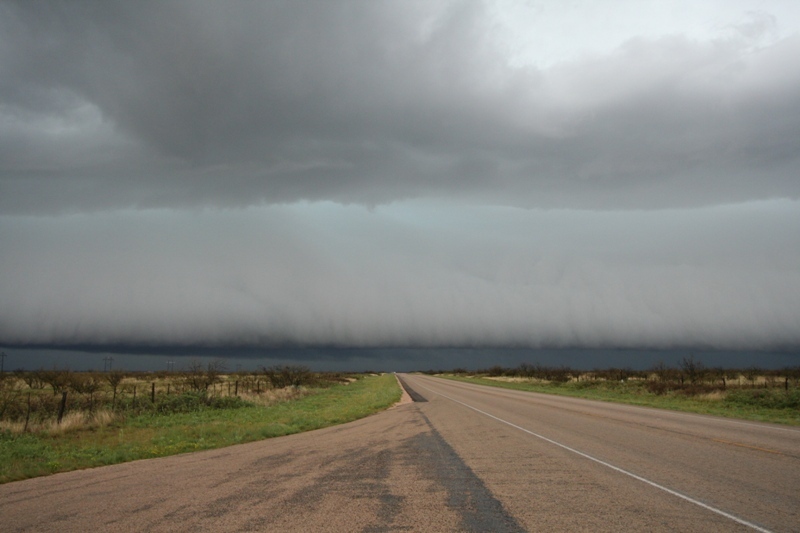 Low, green guster down the road to the west.  Andrews, Texas.