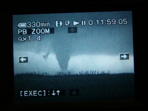 Another flash lit up the tornado.  You can see the debris cloud around the base of the tornado.  Near Macksville, KS.