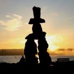 An Inukshuk overlooks the setting sun at English Bay 