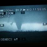 Another flash lit up the tornado.  You can see the debris cloud around the base of the tornado.  Near Macksville, KS.